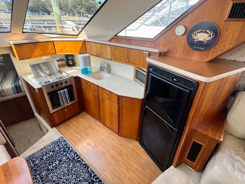 Slide: The Image of Interior of 2000 Silverton 392 Motor Yacht featuring kitchen area. - 15