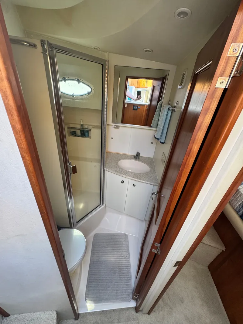 Slide: The Image of 2000 Silverton 392 Motor Yacht bathroom with shower and sink. - 25
