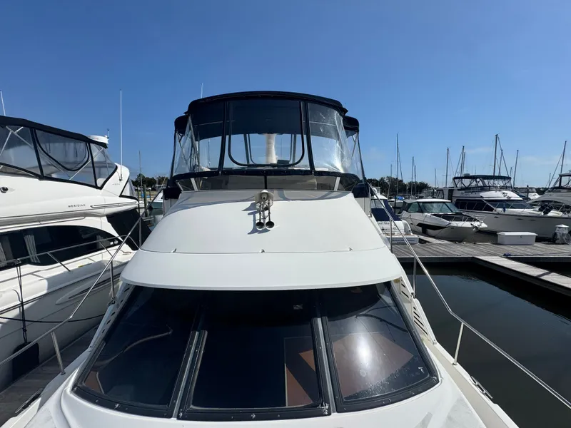 Slide: The Image of 2000 Silverton 392 Motor Yacht docked in sunny marina. - 4