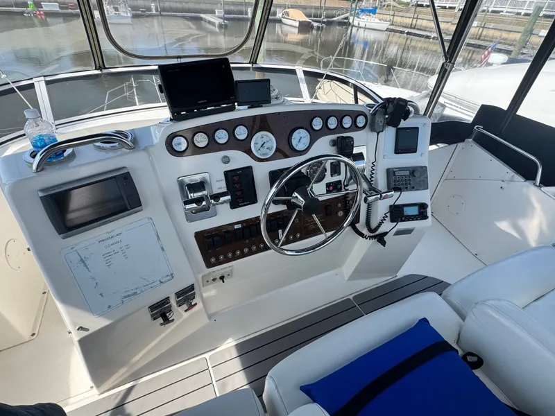 Slide: The Image of 2000 Silverton 392 Motor Yacht helm station in harbor. - 9