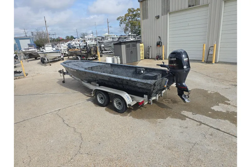 Slide: The Image of Custom Rene Gros 2022 boat on trailer with Yamaha outboard motor, parked outside. - 4