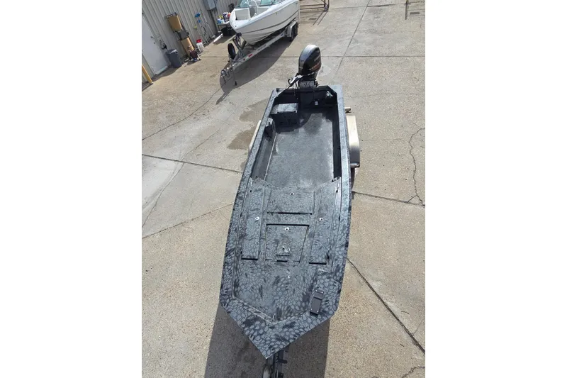 Slide: The Image of Custom 2022 Rene Gros boat on trailer, textured surface, parked outdoors. - 8