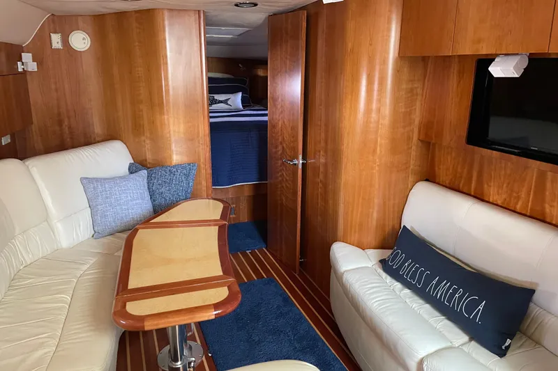 Slide: The Image of Luxurious 2005 Tiara Yachts 4400 Sovran interior with elegant wood finish and cozy seating. - 14