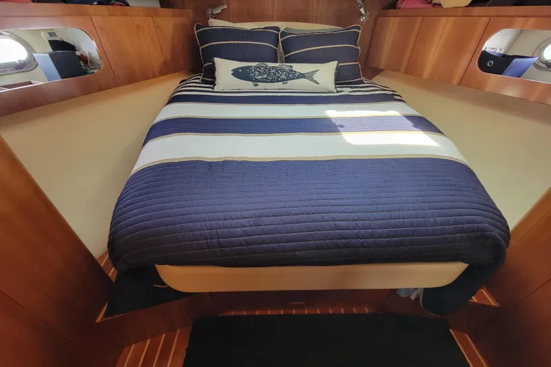 Slide: The Image of Luxurious cabin interior of 2005 Tiara Yachts 4400 Sovran with striped bedding. - 17