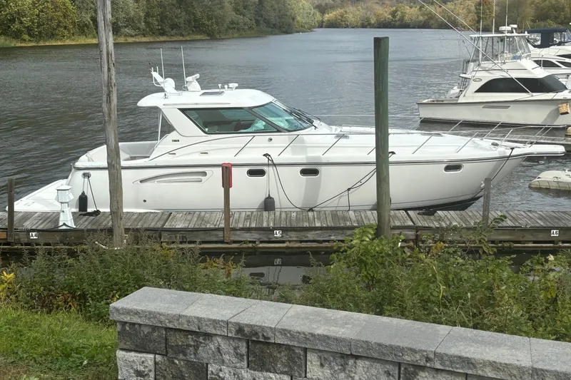 Slide: The Image of 2005 Tiara Yachts 4400 Sovran docked on a serene river. - 5