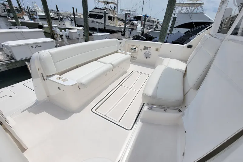 Slide: The Image of 2005 Tiara Yachts 4400 Sovran cockpit with white seating and marina view. - 6