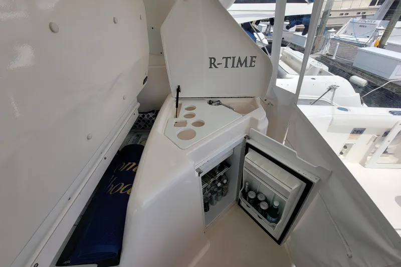 Slide: The Image of 2005 Tiara Yachts 4400 Sovran with open mini fridge and cup holders on deck. - 7