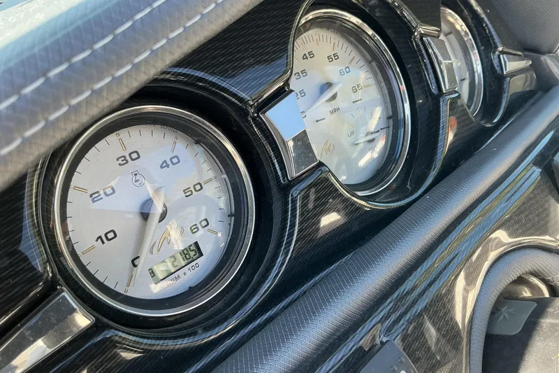 Slide: The Image of Dashboard gauges of a 2018 Monterey 224FS boat, featuring speedometer and tachometer. - 10