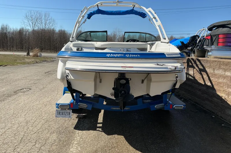 Slide: The Image of 2018 Monterey 224FS boat on trailer, rear view, parked outdoors. - 4