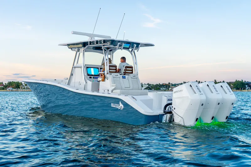 Slide: The Image of 2027 Billfish 39 boat with triple Mercury engines cruising on calm water. - 12