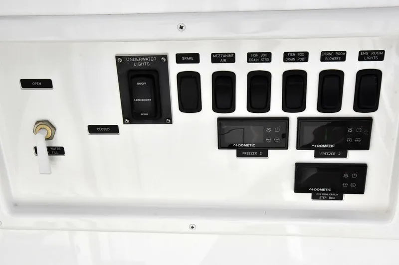 Slide: The Image of Control panel of a 2019 Viking 80 Sky Bridge yacht with various switches and displays. - 106