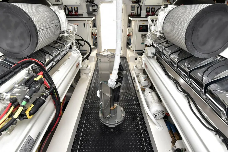 Slide: The Image of Engine room of 2019 Viking 80 Sky Bridge yacht, showcasing dual engines and intricate wiring. - 117