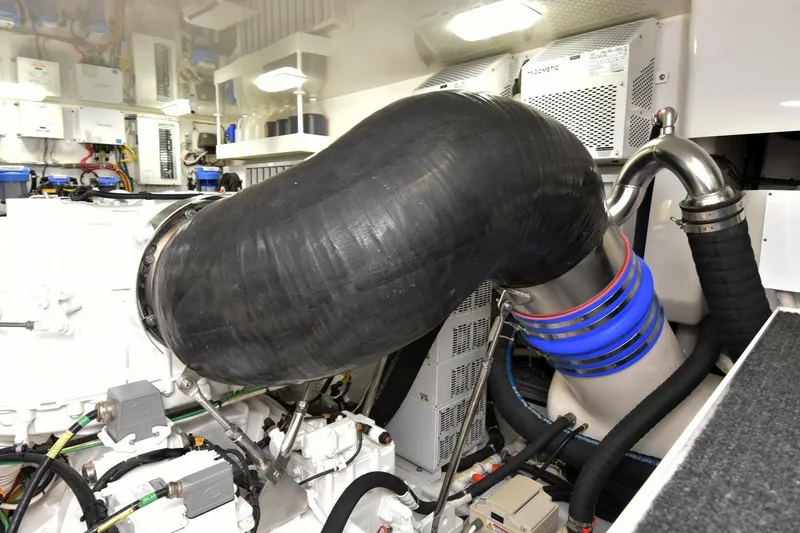 Slide: The Image of Engine room of 2019 Viking 80 Sky Bridge yacht with complex piping and machinery. - 118