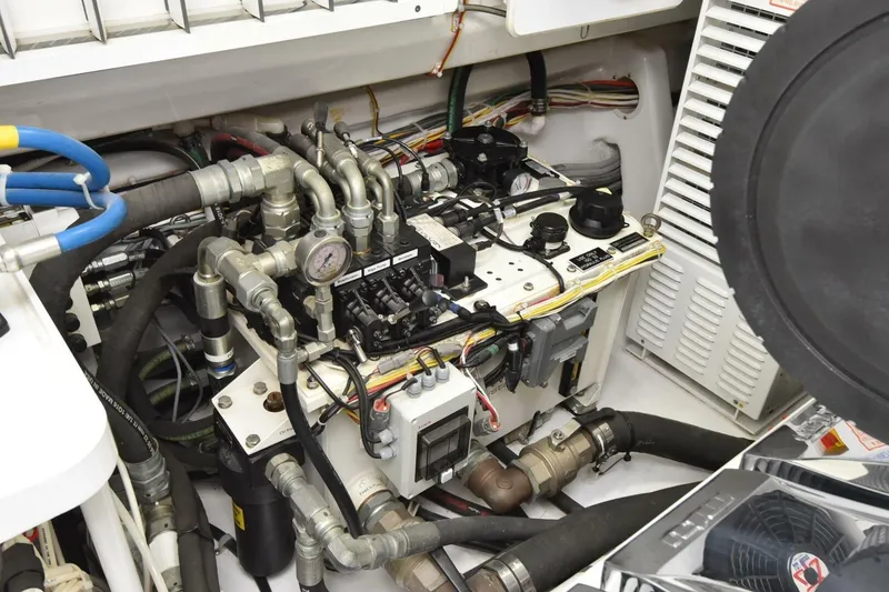 Slide: The Image of Engine room of 2019 Viking 80 Sky Bridge yacht with complex mechanical components. - 119