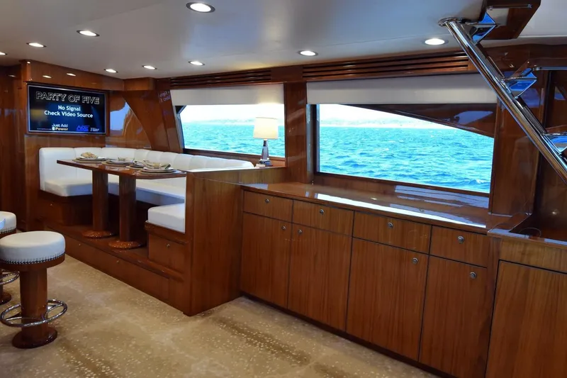 Slide: The Image of Luxurious interior of 2019 Viking 80 Sky Bridge yacht with ocean view and elegant dining area. - 12