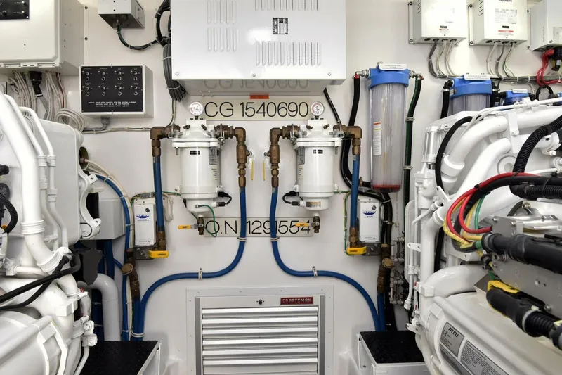 Slide: The Image of Engine room of 2019 Viking 80 Sky Bridge yacht, showcasing machinery and piping systems. - 121