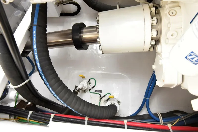 Slide: The Image of Engine room of 2019 Viking 80 Sky Bridge yacht, showcasing mechanical components and hoses. - 122