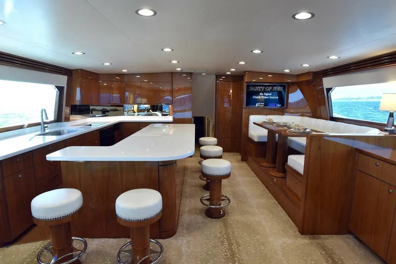 Slide: The Image of Luxurious interior of 2019 Viking 80 Sky Bridge yacht with modern kitchen and dining area. - 21