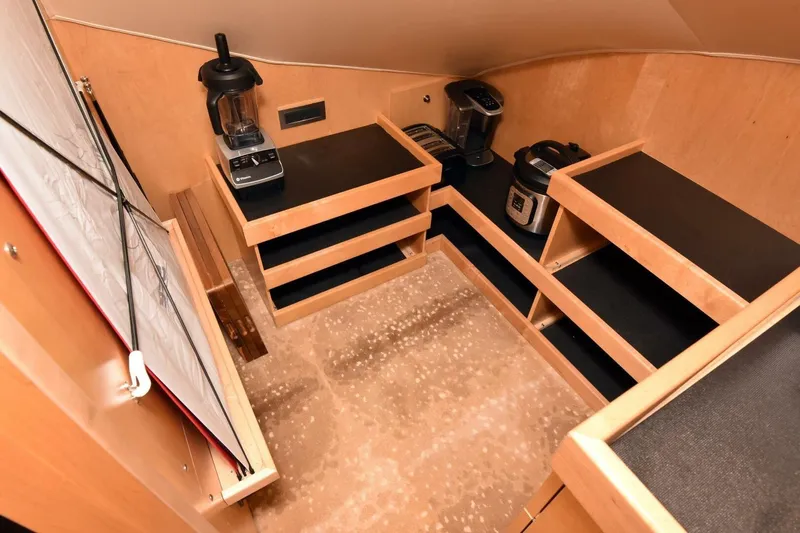 Slide: The Image of 2019 Viking 80 Sky Bridge yacht kitchen with appliances and wooden cabinetry. - 25