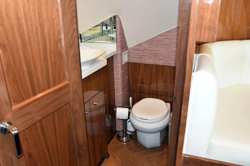 Slide: The Image of Luxurious bathroom interior of 2019 Viking 80 Sky Bridge yacht, featuring wood accents and modern fixtures. - 26