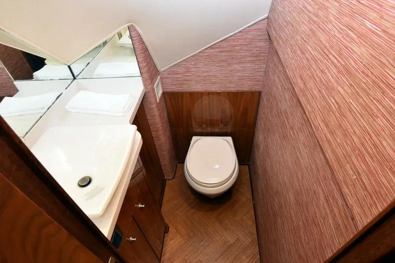 Slide: The Image of Luxurious bathroom in 2019 Viking 80 Sky Bridge yacht with modern fixtures and wood accents. - 27