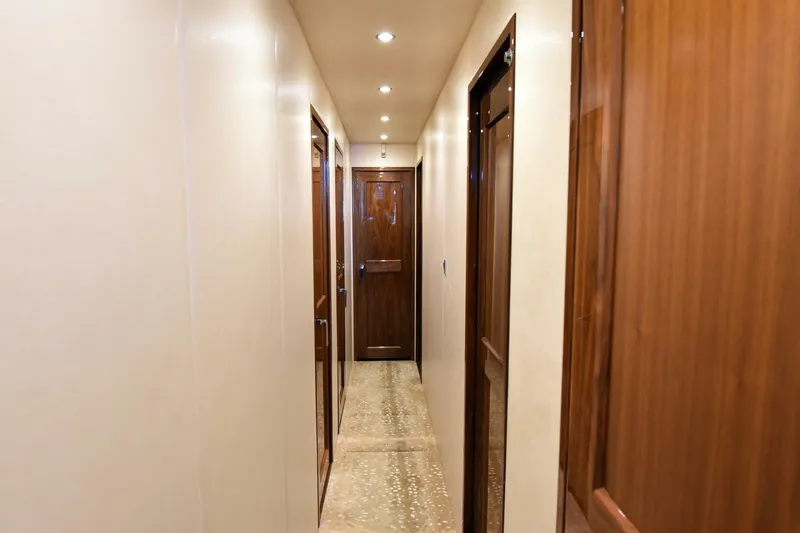 Slide: The Image of Luxurious hallway interior of 2019 Viking 80 Sky Bridge yacht with wooden doors. - 28