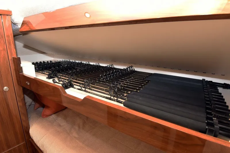 Slide: The Image of Storage compartment with fishing rods on a 2019 Viking 80 Sky Bridge yacht. - 32