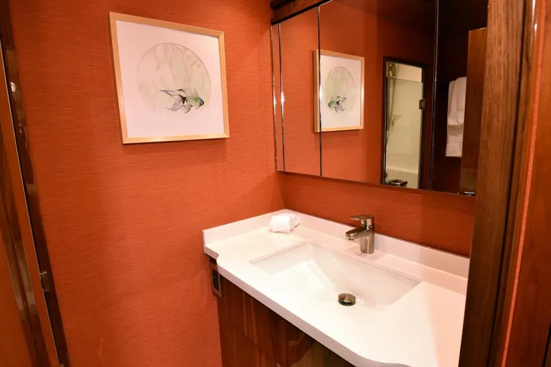 Slide: The Image of Luxurious bathroom on 2019 Viking 80 Sky Bridge yacht with modern sink and fish artwork. - 34