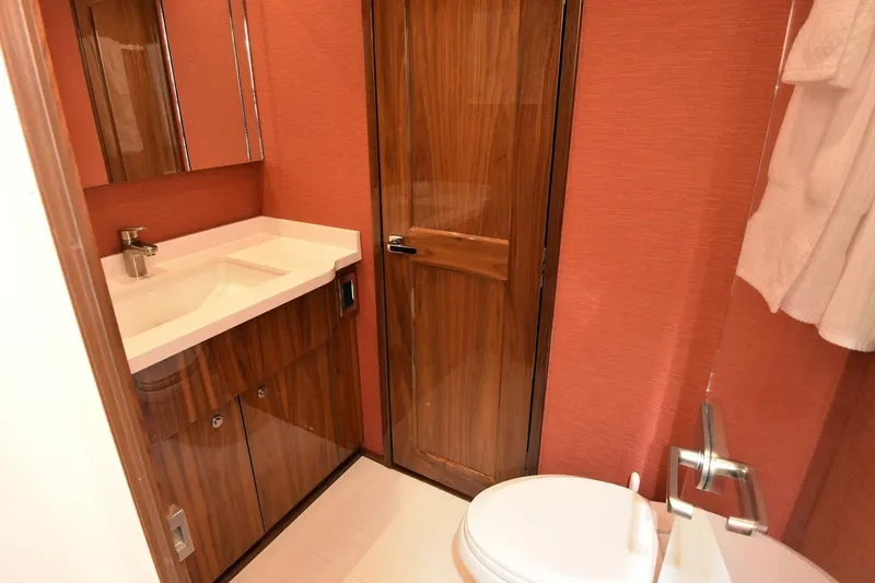 Slide: The Image of Luxurious bathroom on 2019 Viking 80 Sky Bridge yacht with wood accents and modern fixtures. - 35