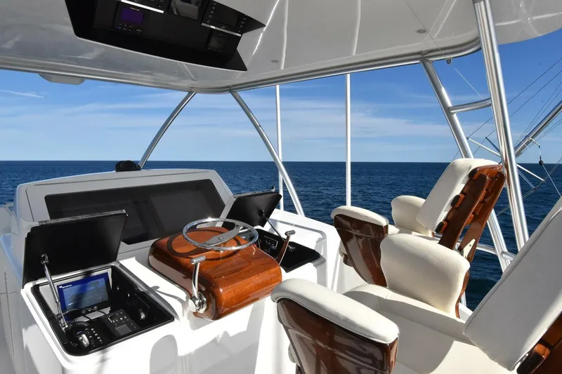 Slide: The Image of 2019 Viking 80 Sky Bridge helm with luxurious seating and ocean view. - 65