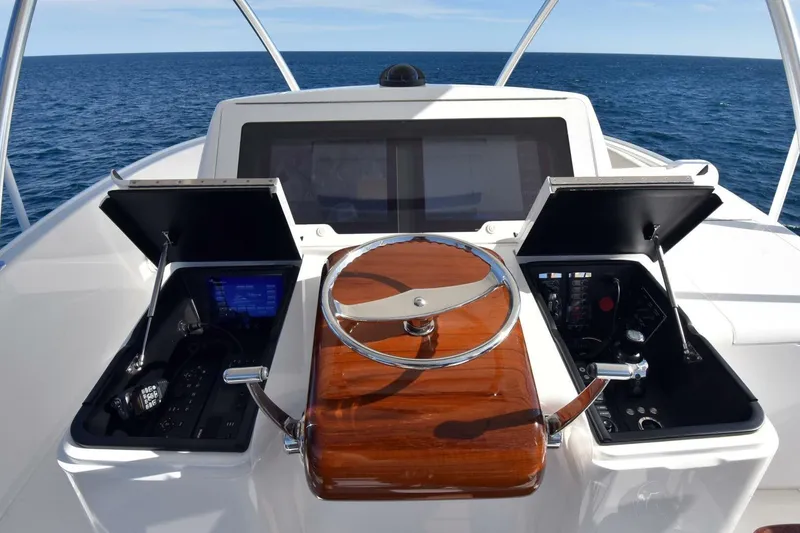 Slide: The Image of 2019 Viking 80 Sky Bridge yacht helm with ocean view and advanced controls. - 66
