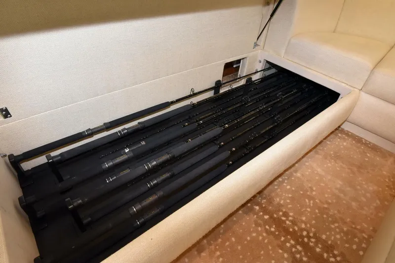 Slide: The Image of Fishing rod storage in 2019 Viking 80 Sky Bridge yacht, under-seat compartment. - 7