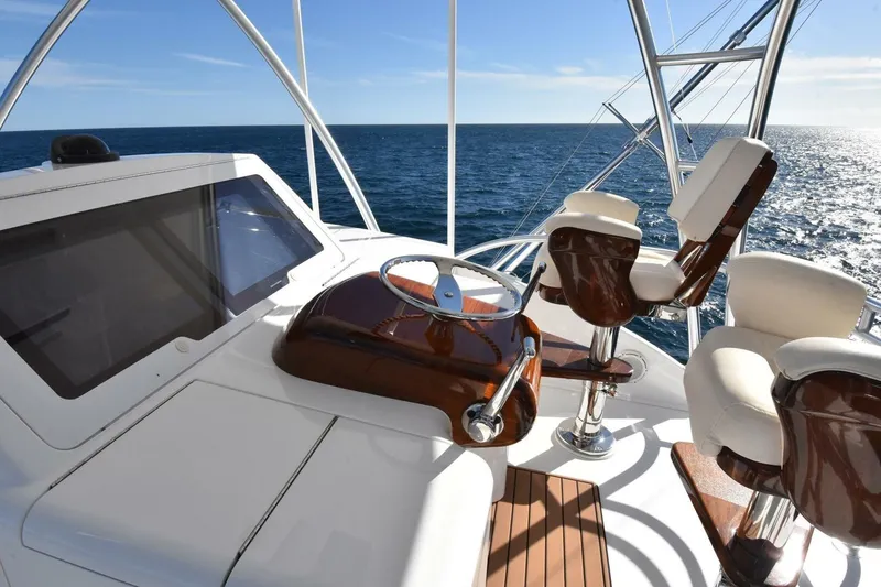 Slide: The Image of 2019 Viking 80 Sky Bridge yacht helm with ocean view and luxurious seating. - 72