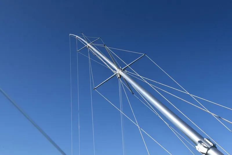 Slide: The Image of Mast of 2019 Viking 80 Sky Bridge yacht against clear blue sky. - 75