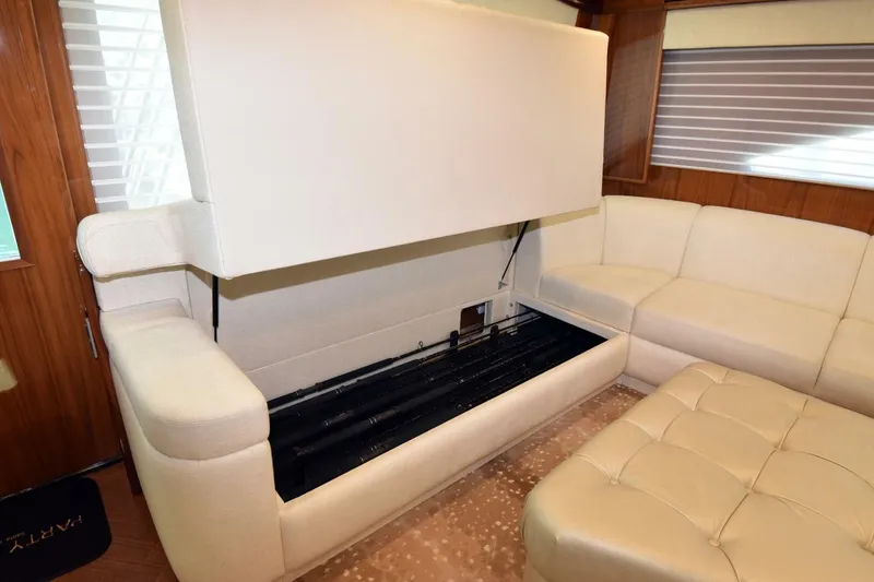 Slide: The Image of Luxurious interior of 2019 Viking 80 Sky Bridge yacht with hidden storage under seating. - 8