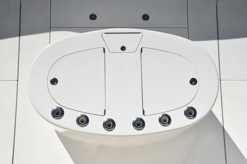 Slide: The Image of White deck hatch on 2019 Viking 80 Sky Bridge yacht, featuring multiple circular fittings. - 88