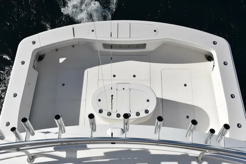 Slide: The Image of 2019 Viking 80 Sky Bridge yacht deck with fishing rod holders and spacious layout. - 96