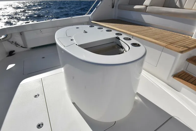 Slide: The Image of 2019 Viking 80 Sky Bridge yacht deck with seating and fishing station. - 98