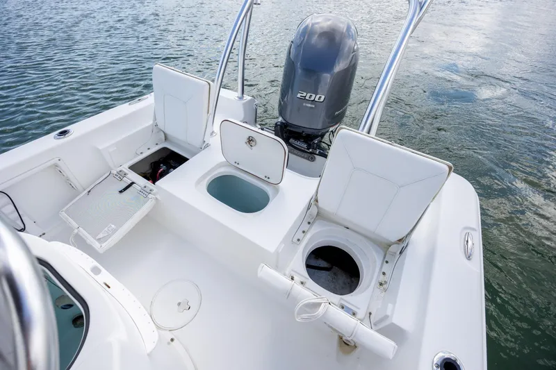 Slide: The Image of 2015 Sea Hunt BX 22 Pro boat with open storage compartments and Yamaha 200 engine. - 11