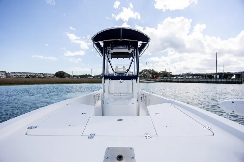 Slide: The Image of 2015 Sea Hunt BX 22 Pro boat on calm water under a partly cloudy sky. - 13