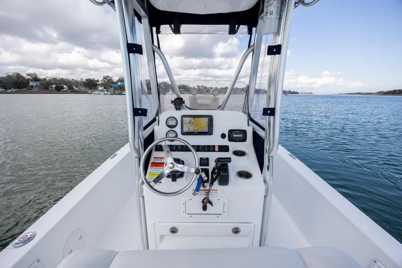 Slide: The Image of 2015 Sea Hunt BX 22 Pro boat dashboard with steering wheel and navigation system. - 15