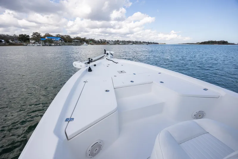 Slide: The Image of 2015 Sea Hunt BX 22 Pro boat on calm water under a partly cloudy sky. - 16