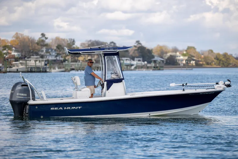 Slide: The Image of 2015 Sea Hunt BX 22 Pro boat on water, with Yamaha engine, scenic background. - 6