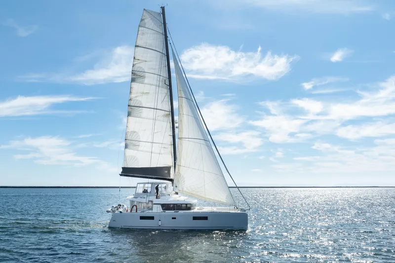 The Image of 2022 Lagoon 52 F catamaran sailing on a sunny day with clear skies. - 1