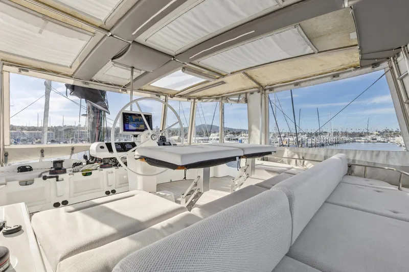 Slide: The Image of Luxurious 2022 Lagoon 52 F yacht interior with helm, seating, and marina view. - 11