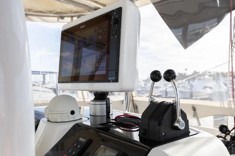 Slide: The Image of Control panel of a 2022 Lagoon 52 F yacht with navigation display and throttle levers. - 19