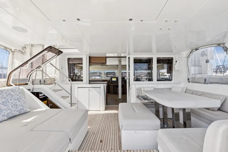 Slide: The Image of Luxurious interior of 2022 Lagoon 52 F catamaran with modern seating and dining area. - 24