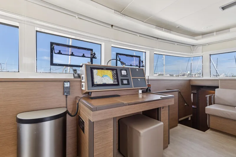 Slide: The Image of Modern navigation station inside 2022 Lagoon 52 F yacht, featuring advanced equipment and sleek design. - 28