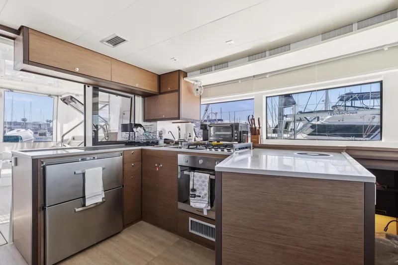 Slide: The Image of Modern kitchen interior of 2022 Lagoon 52 F yacht, featuring sleek cabinetry and appliances. - 31