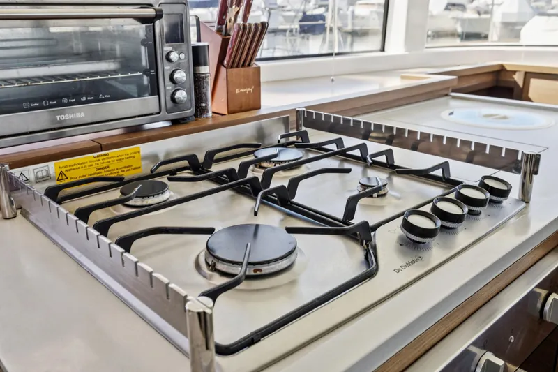 Slide: The Image of Modern kitchen stove and oven on 2022 Lagoon 52 F yacht. - 32